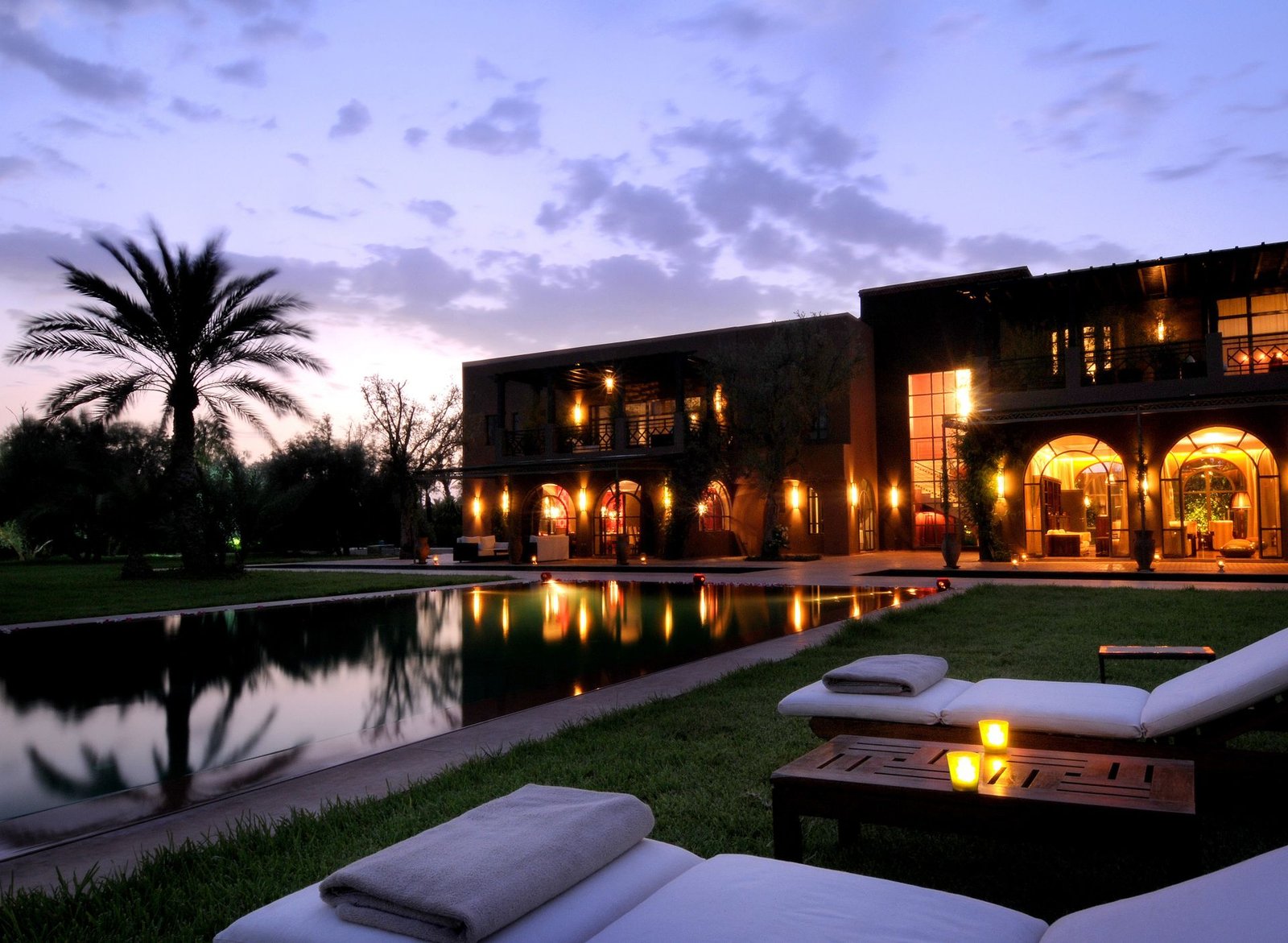 Candlelit private villa terrace and pool at dusk
